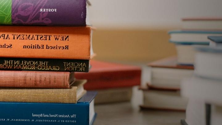 Books from several disciplines stacked in a pile.