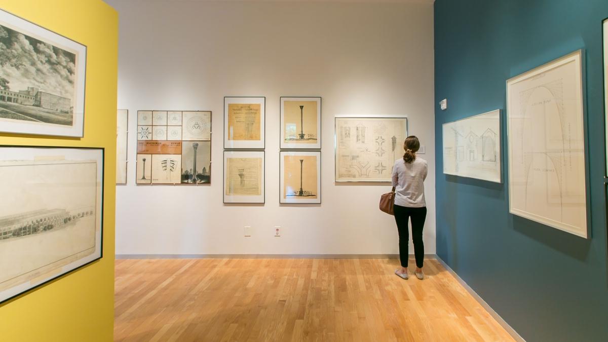 a woman pauses in front of an oneil ford drawing in the trinity art gallery